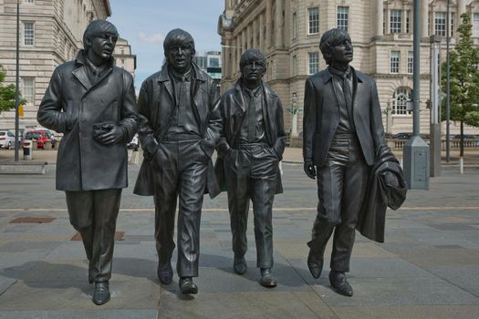 LIVERPOOL, ENGLAND, UK - JUNE 07, 2017: A bronze statue of the four Liverpool Beatles stands on Liverpool Waterfront, weighing in at 1.2 tonnes and sculpted by sculpture Andrew Edwards.