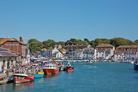 WEYMOUTH, DORSET, ENGLAND, UK - AUGUST 15, 2017: View of a port and bay in Weymouth in UK during beautiful sunny summer day.