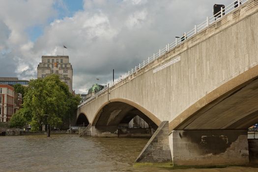 LONDON, UK - SEPTEMBER 08, 2017: Waterloo Bridge in London UK showing the Waterloo Bridge sign and taken from a boat on the river Thames.