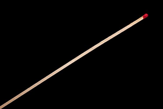one long matchstick isolated on black background