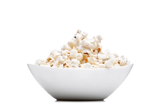 white bowl with popcorn against white background