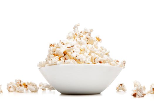 white bowl with popcorn against white background