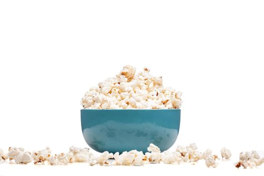 blue bowl with popcorn against white background