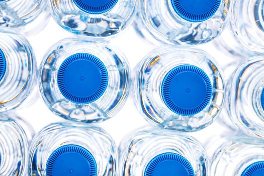 pile of plastic bottles of half litre with blue cap