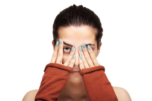 beautiful girl peaking while hiding her face with her hands