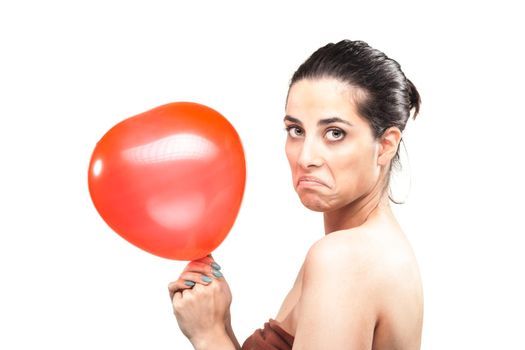 unhappy sad girl with a red heart shaped balloon, isolated on white background