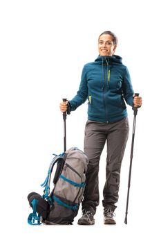 girl with hiking equipment and large backpack, posing in studio isolated on white