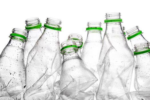 group of smashed empty plastic bottles with green caps, isolated on white background