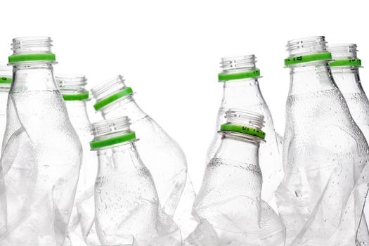 group of smashed empty plastic bottles with green caps, isolated on white background