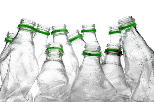 group of smashed empty plastic bottles with green caps, isolated on white background