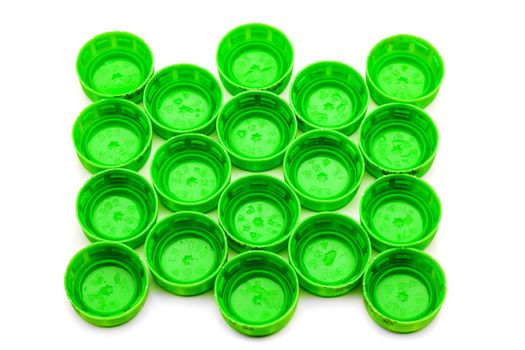group of green bottle caps against white surface