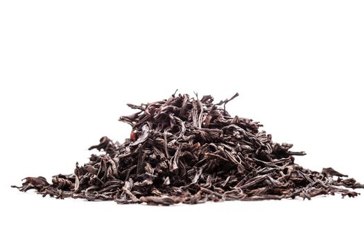 pile of black tea leaves against white backgorund