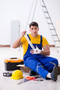Worker with injured hand at construction site