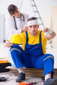 Worker with injured head and doctor