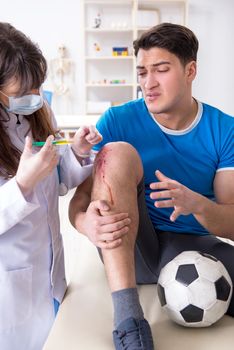 Football soccer player visiting doctor after injury