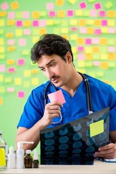 Young doctor with many reminders and urgent work