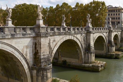 ROME, ITALY - SEPTEMBER 28, 2010: Tourists Crossing the Bridge In Front Of Castel Sant'Angelo in Rome Italy
