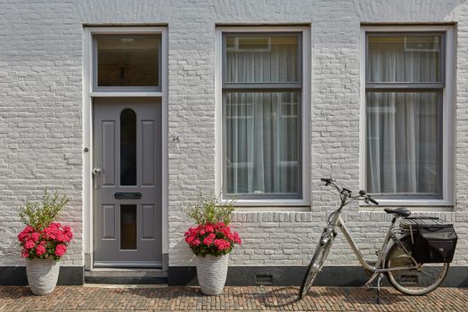 VLISSINGEN, NETHERLANDS - JUNE 15, 2017: House entrance decorated with flowers. Rustic style concept. Beautiful design elements of unknown building in Vlissengen Netherlands.