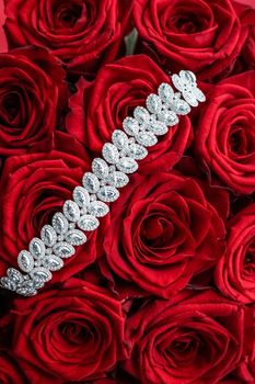 Gemstone jewellery, wedding fashion and luxe shopping concept - Luxury diamond bracelet and bouquet of red roses, jewelry love gift on Valentines Day and romantic holidays present