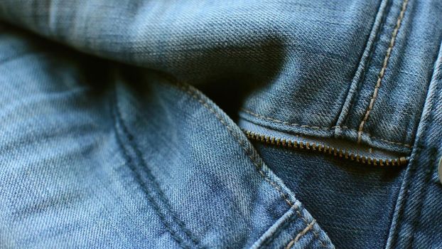 close up detail of blue denim jeans, texture background 