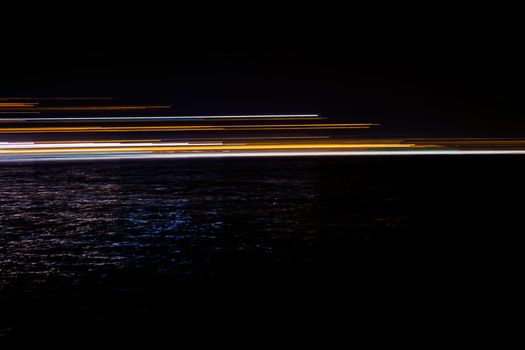 abstract lights in the dark reflected in water