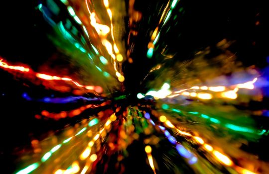 Abstract motion defocused lights on dark background