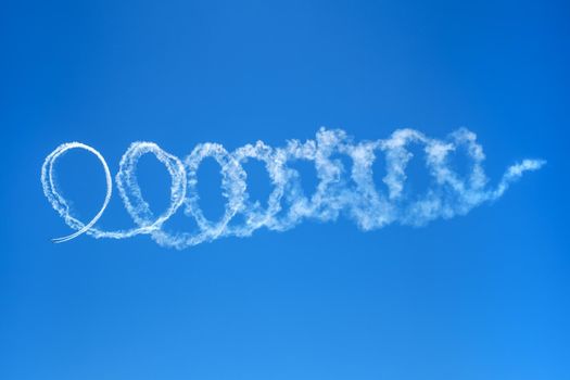 Abstract skywriting design with spiraling circles of vapor