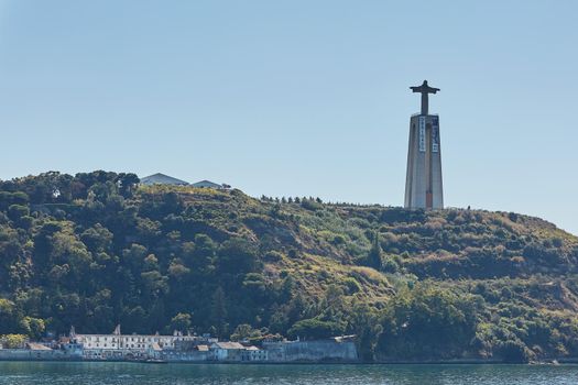 LISBON / PORTUGAL - OCTOBER 02, 2017: Catholic monument of Cristo Rei or Christ the King. Viewed from a distance of Almada, Lisbon, Portugal