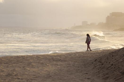 salvador, bahia / brazil - june 2, 2018: People are seen walking alone along the Rio Vermelho beach in Salvador.