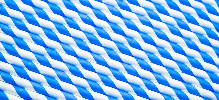 blue spiral striped drinking straws isolated on white background