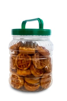 In a glass jar with a lid delicious cookies. Presented on a white background.