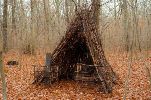hut made of branches for animals on a forest