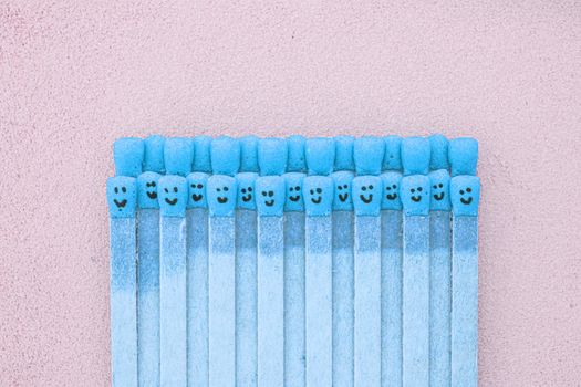 matchsticks with faces painted on the heads with natural leather background