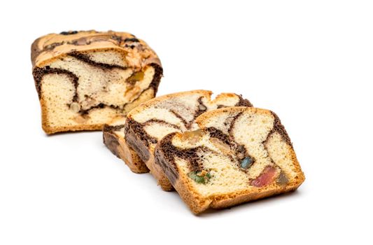 Slices of Romanian sponge cake with cocoa, turkish delight and raisins
