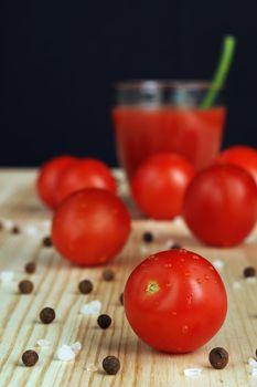 Fresh tomatoes, red tomatoes. Tomato juice freshly squeezed in a transparent glass. High quality photo