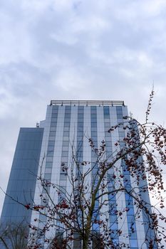 the blue glass building on cloudy sky