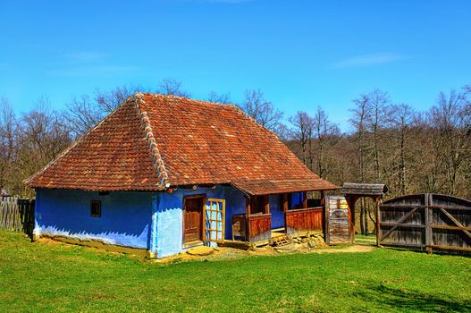 traditional Romanian clay house with grass yard