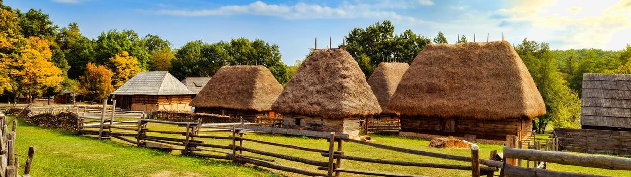 Traditional Romanian village with old house straw roofing and wooden fences