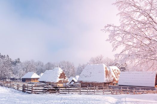 Traditional Romanian village in Transylvania with old house straw roofing covered with snow in a cold day