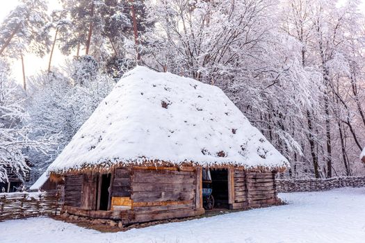 Traditional Romanian village in Transylvania with old house straw roofing covered with snow in a cold day