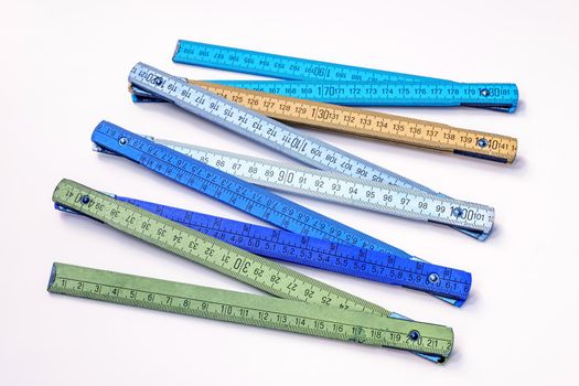 Vintage multicolored wooden folding ruler isolated on a white background