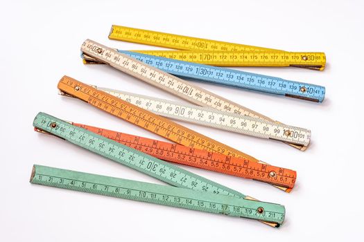 Vintage multicolored wooden folding ruler isolated on a white background