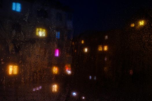 Water drops reflections on the window in night