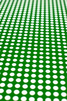 white dots on a green background