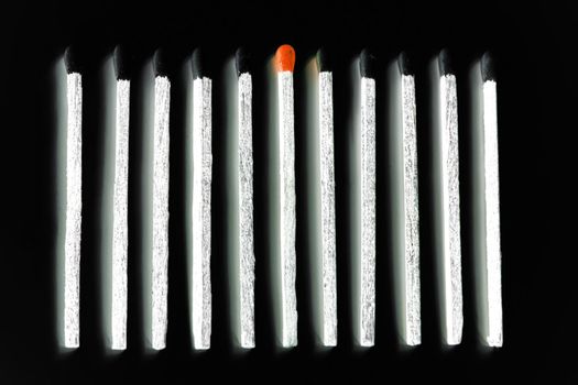white matches with black heads and one with red head isolated over black
