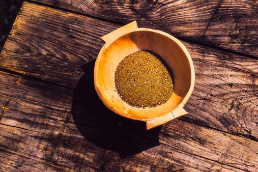 wooden bowl with sand on the old table