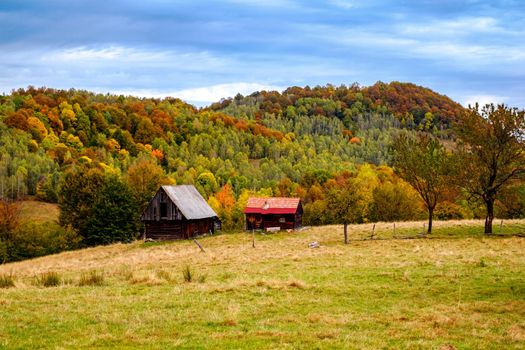Colorful autumn landscape in the Romanian Carpathians, Fantanele village, Sibiu county, Cindrel mountains, 1100m, Romania