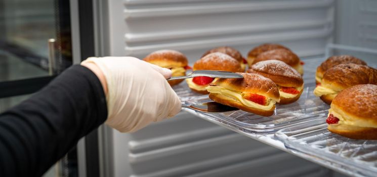 donut stuffed with cream and strawberries in the fridge.