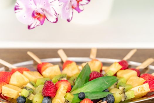 fruit skewers on a tray in celebration.
