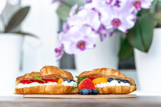 breakfast, croasant filled with vanilla cream and fruit.